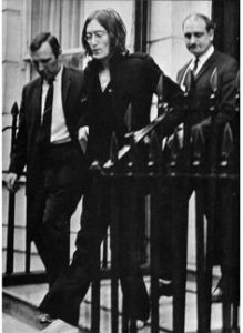 John being led away by the police from Montagu Square