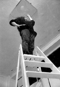 Yoko Ono demonstrating 'Ceiling Painting'