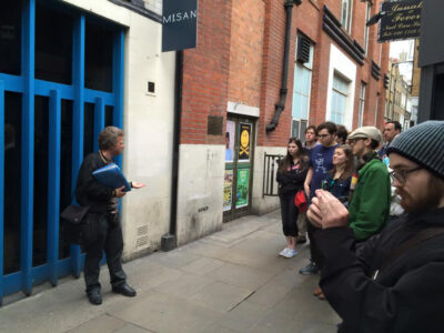 Guide Richard Porter with his tour group Outside Trident Studios on a London Beatles walking tour