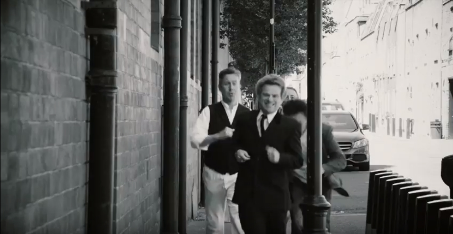 Fans on a London Beatles Walk recreating the opening scenes of a Hard Day's Night