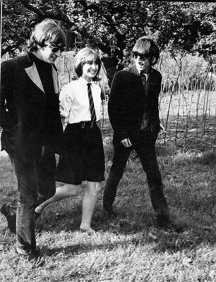 John Lennon and George Harrison in Chiswick House Park with a fan